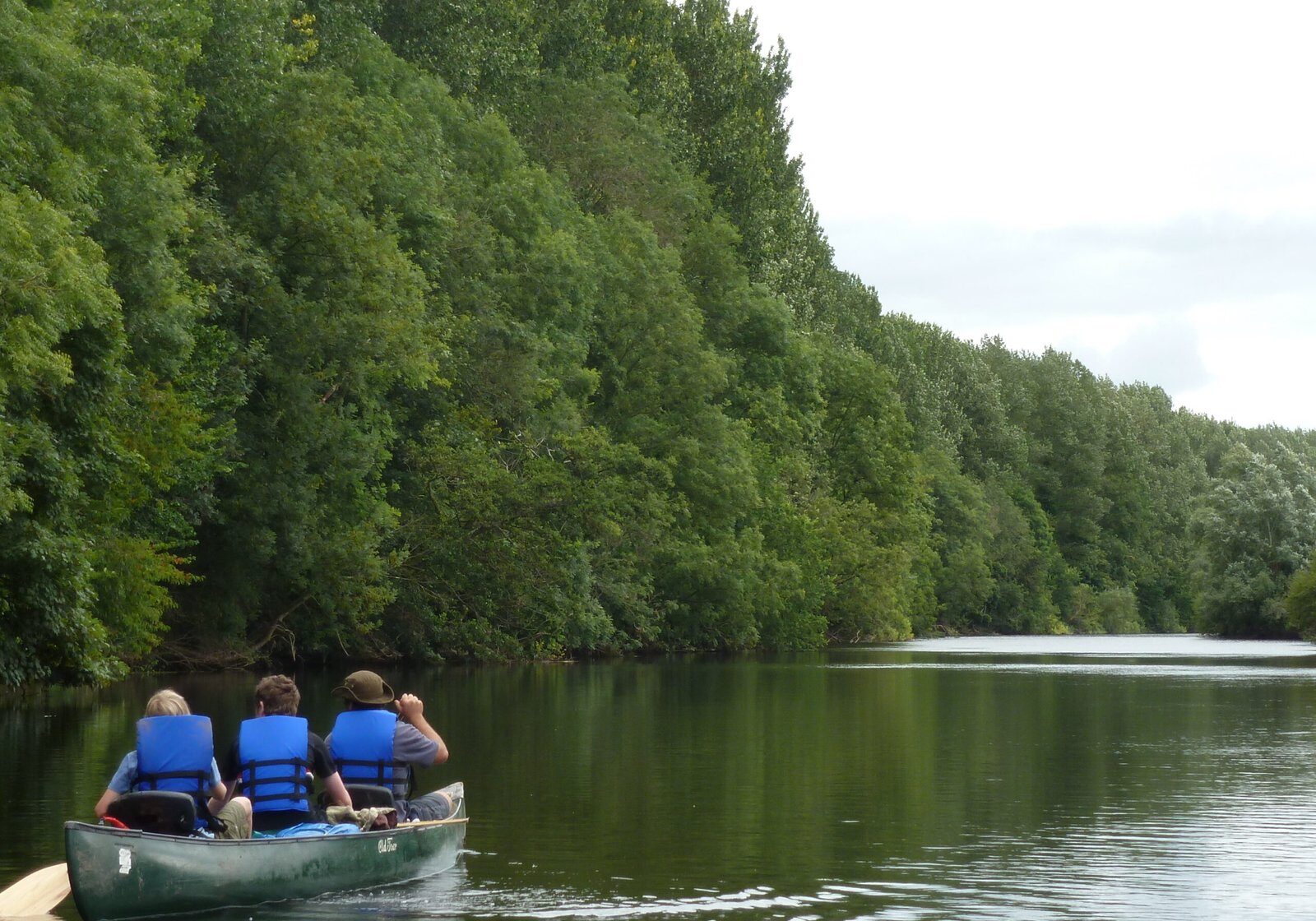 3 men in a canoe on a lake