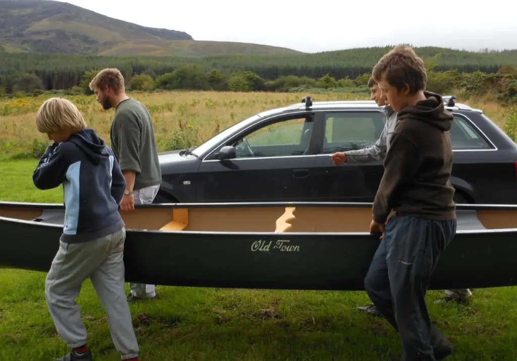 Boys carrying canoe